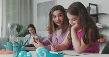 Young girls connecting to social media using their smartphone
