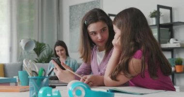 Young girls connecting to social media using their smartphone