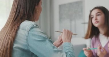 Woman helping children with their homework