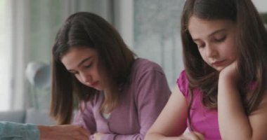 Woman helping children with their homework