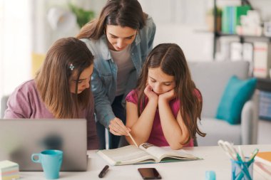 Happy students doing homework together, education and learning at home concept