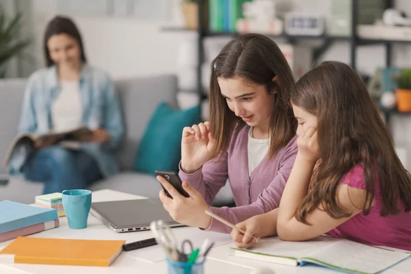 Happy Girls Sitting Desk Home Studying Together One Them Using — Stockfoto