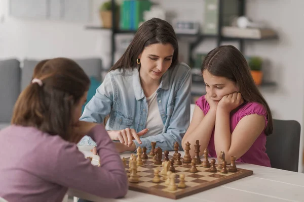 Young Mother Teaching Chess Her Kids Sitting Together Playing — Foto Stock