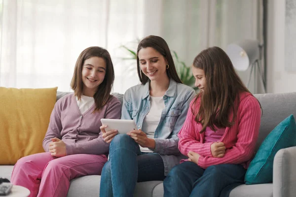 Happy Girls Sitting Sofa Connecting Digital Tablet Watching Movies Online — ストック写真