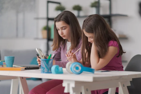 Cute Schoolgirls Doing Homework Together Sitting Desk Living Room — Φωτογραφία Αρχείου