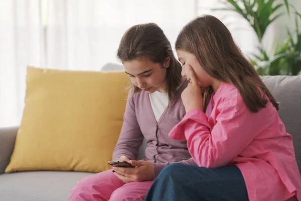 Cute Children Sitting Sofa Living Room Using Smartphone Together —  Fotos de Stock