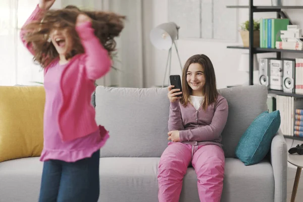 Happy Girl Shooting Video Her Friend Dancing Living Room — Fotografia de Stock