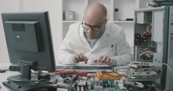 Técnico enojado trabajando en una computadora rota — Vídeo de stock