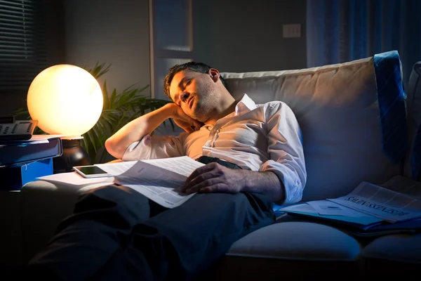 Overworked businessman on sofa — Stock Photo, Image