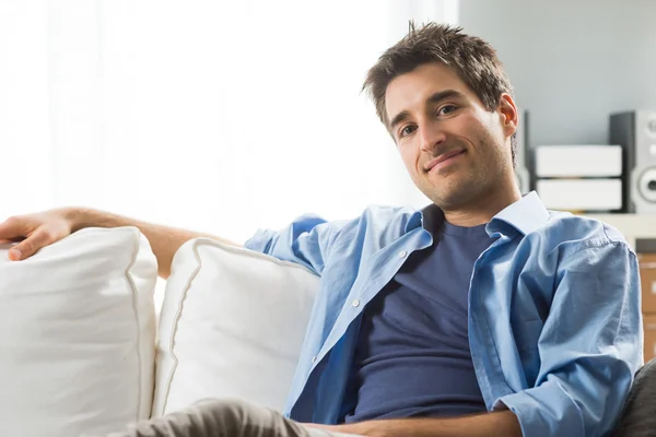 Young man relaxing on sofa — Stock Photo, Image