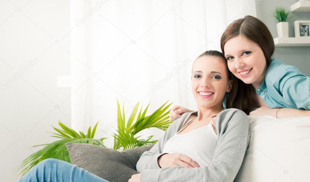 Smiling girlfriends in the living room