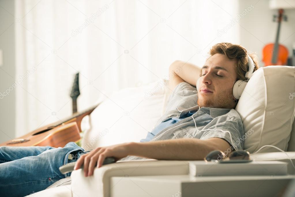 Guy with headphones on sofa