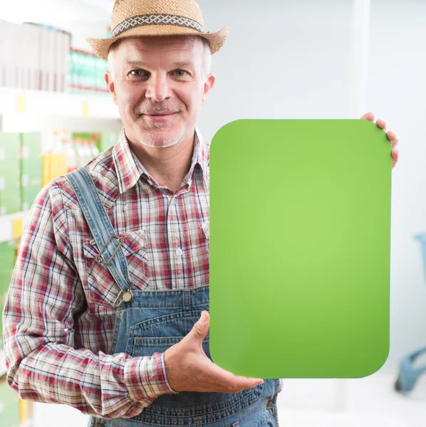 Boer houden teken in supermarkt — Stockfoto