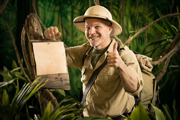 Cheerful explorer thumbs up with sign — Stock Photo, Image