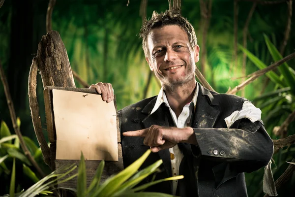 Survivor businessman pointing at sign — Stock Photo, Image