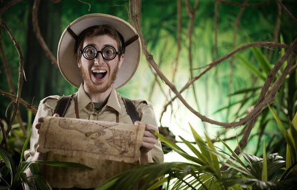 Explorer in jungle holding map