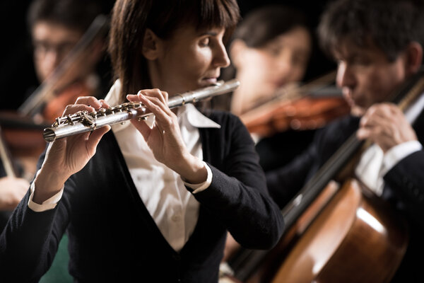 Female flutist with orchestra
