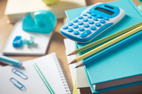 Calculator on books with stationery — Stock Photo, Image