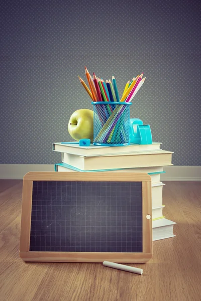 Chalkboard, apple and colorful stationery. — Stock Photo, Image