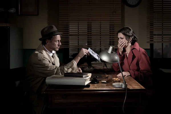 Detective showing a picture woman — Stock Photo, Image