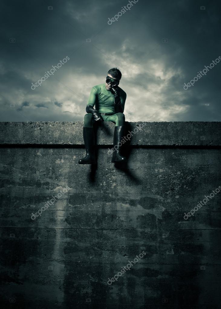 Superhero sitting on concrete wall — Stock Photo © stokkete 56590969