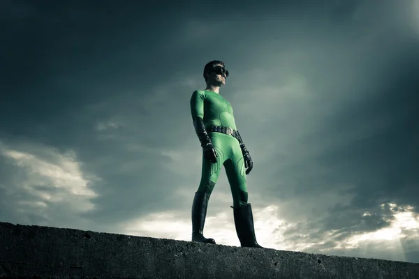 Superhero standing on a concrete wall — Stock Photo, Image