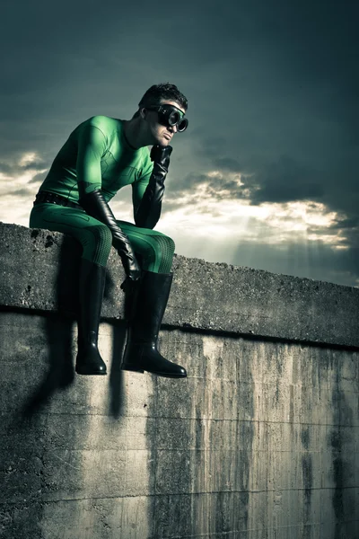 Pensive superhero against dark sky — Stock Photo, Image