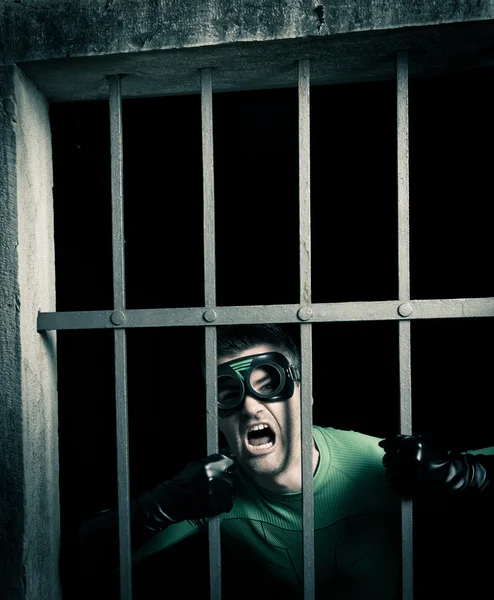 Superherói trancado na prisão — Fotografia de Stock