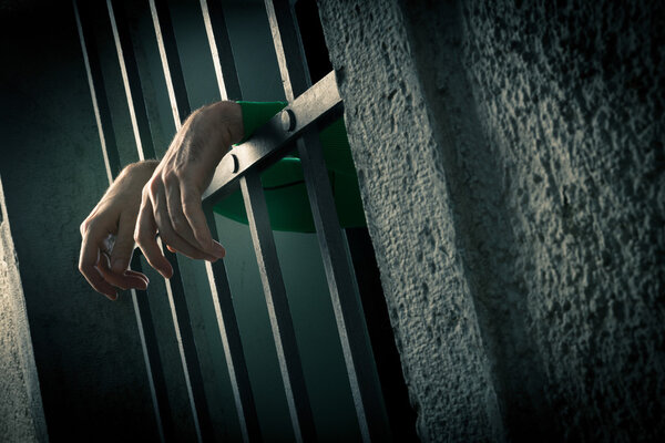 Man in jail hands close-up