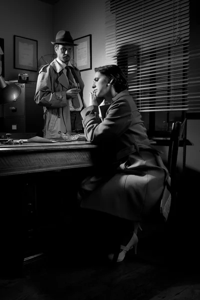 Detective interviewing a young pensive woman in his office — Stock Photo, Image