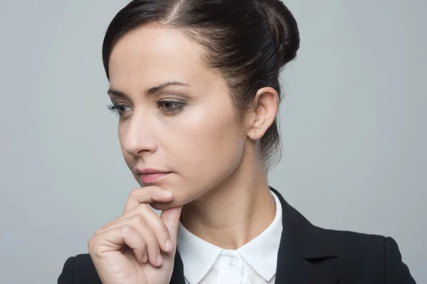 Geschäftsfrau mit der Hand am Kinn — Stockfoto