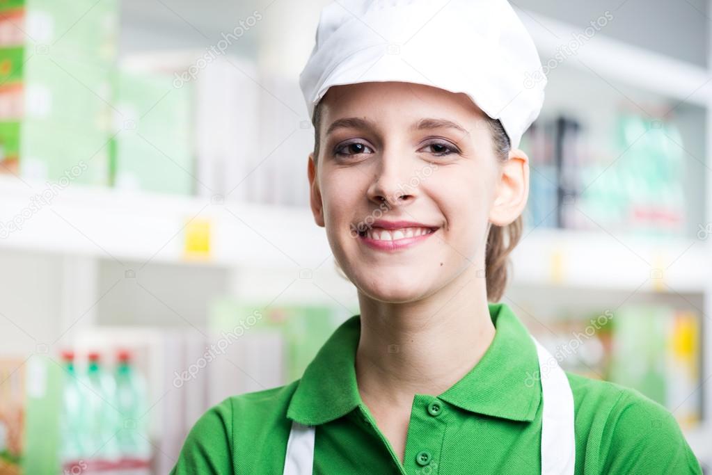 Smiling saleswoman with apron