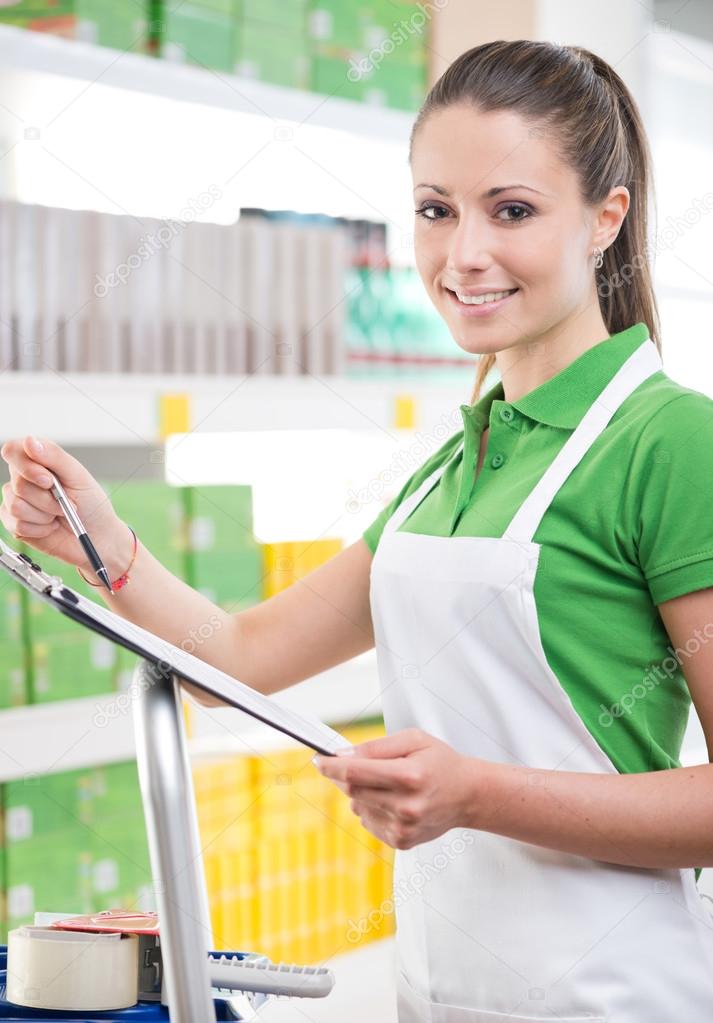 Female sales clerk holding clipboard