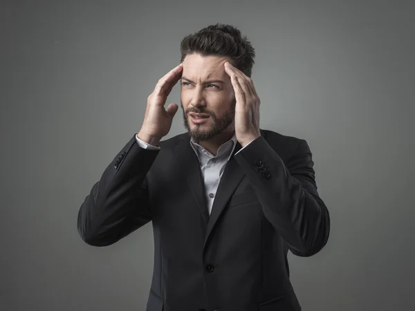 Businessman with head in hands — Stock Photo, Image