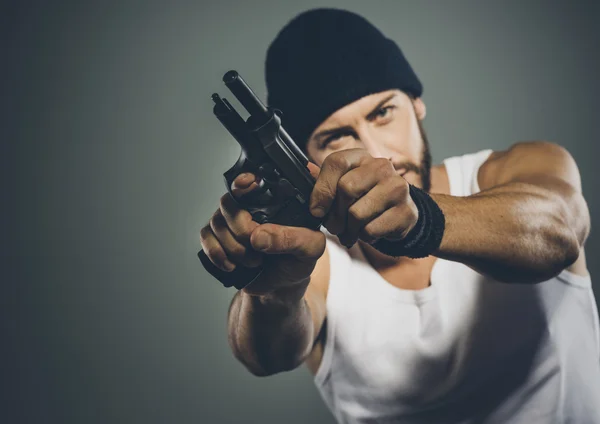 Criminal holding a gun — Stock Photo, Image