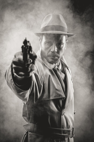 Vintage agent pointing a gun