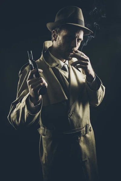 Gangster in trench coat smoking — Stock Photo, Image