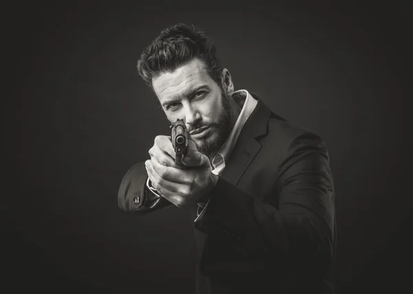 Aggressive man pointing gun — Stock Photo, Image