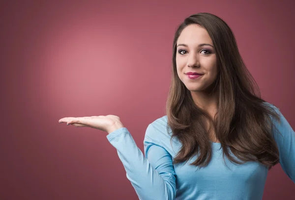 Woman presenting something at her side — Stock Photo, Image