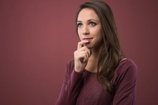 Pensive woman with hand on chin — Stock Photo, Image