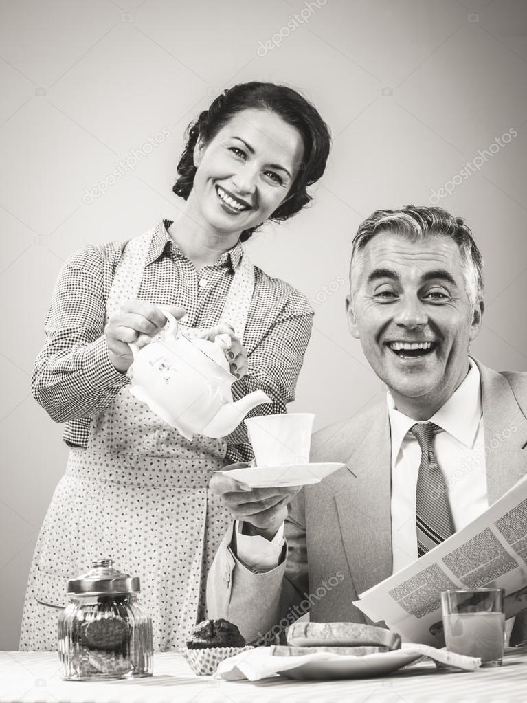 Woman serving tea to her husband