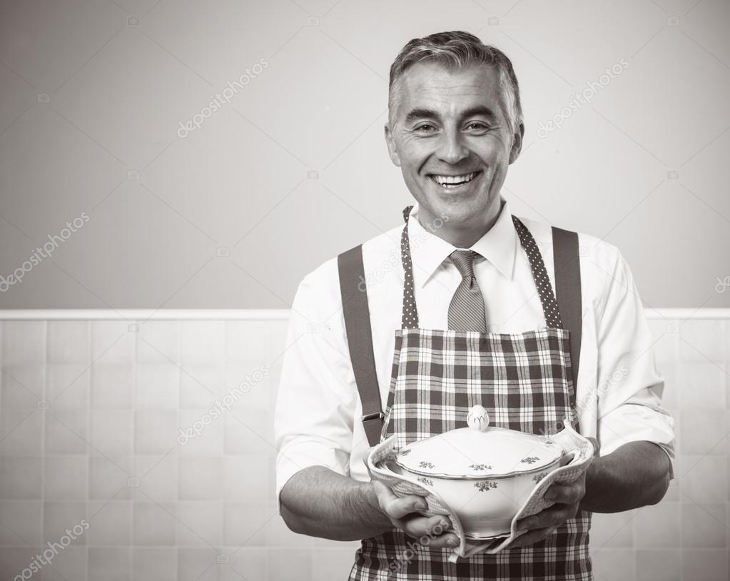 Smiling man in apron serving dinner