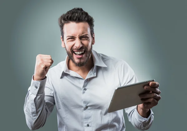Man receiving good news on tablet — Stock Photo, Image