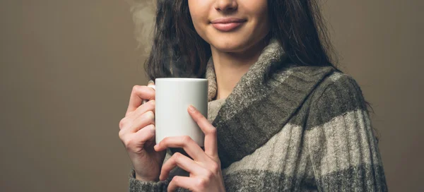Young woman having an hot drink — Stock Photo, Image