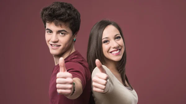 Happy young couple thumbs up — Stock Photo, Image