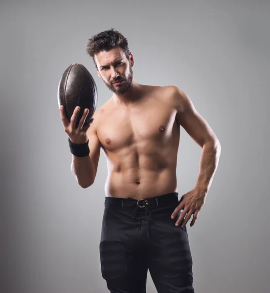 Football player holding ball — Stock Photo, Image