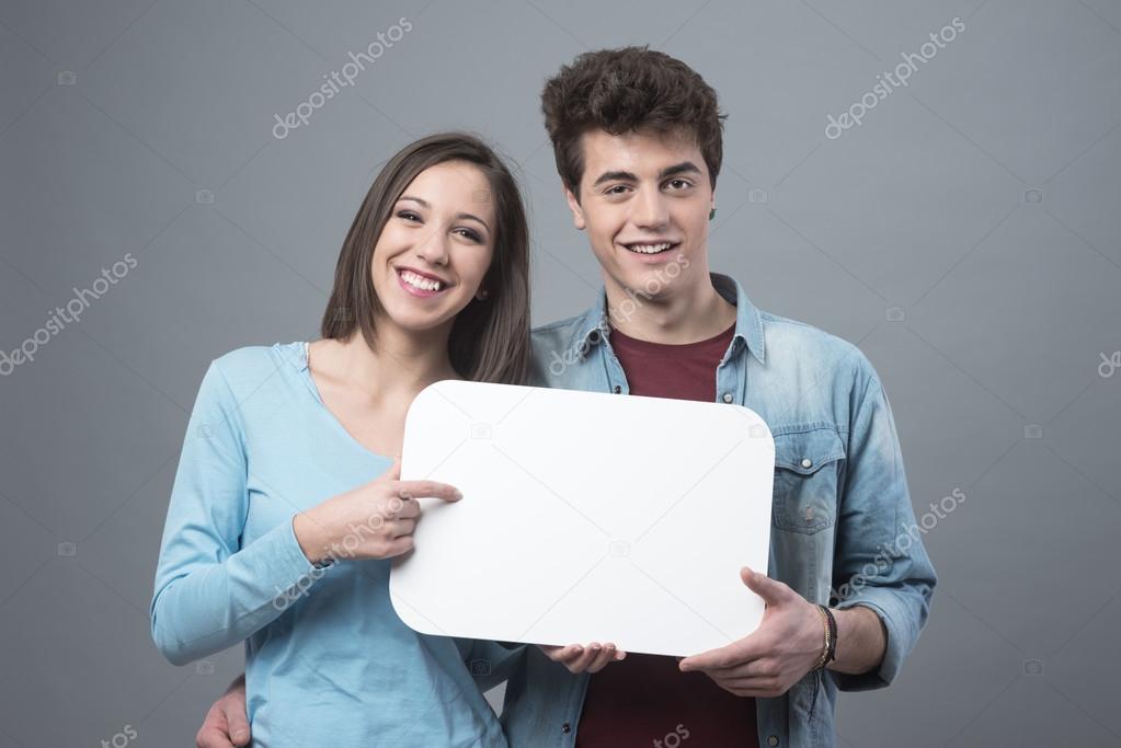 Couple holding  blank white sign