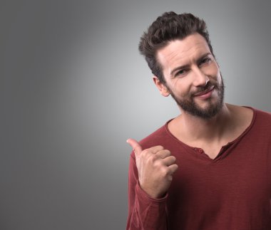 Gülümseyen ve tarafına işaret eden adam