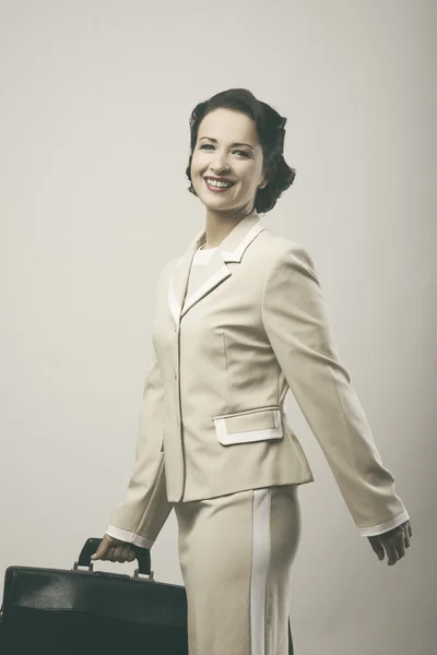 Woman smiling and walking with briefcase — Stock Photo, Image