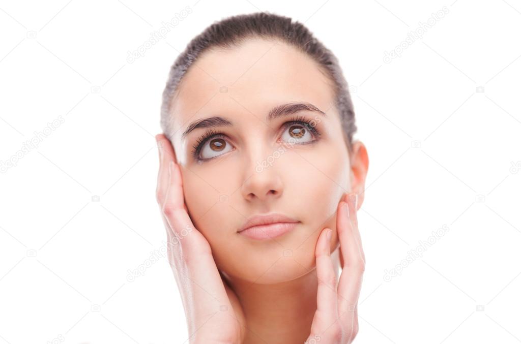 Woman touching her radiant smooth face skin